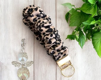 Wrist strap bracelet with leopard print, scrunchie keychain with guardian angel