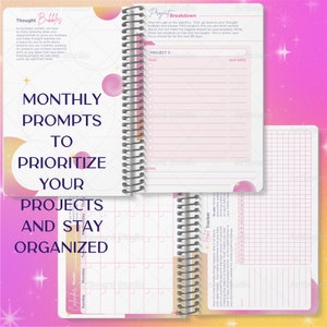 May include: A pink and orange planner with a spiral binding. The cover features the text "Monthly Prompts to Prioritize Your Projects and Stay Organized". The inside pages have sections for project breakdowns, task lists, due dates, notes, and a calendar.