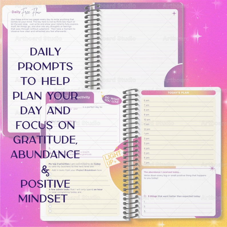 May include: A pink and purple planner with a spiral binding. The cover has the text "Daily Free Flow" and "Daily Prompts to Help Plan Your Day and Focus on Gratitude, Abundance & Positive Mindset". The inside pages have a daily schedule and prompts for gratitude, abundance, and positive mindset.