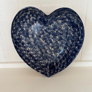May include: A blue and white heart-shaped ceramic bowl with a speckled pattern.