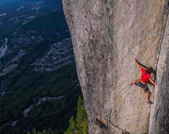 Climber (Sean Villanueva O&#39;Driscoll)  on top of the Stawamus Chief in Squamish, trad climbing Tainted Love, a hard route on the top