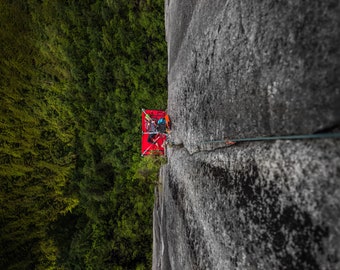 Woman sleeping on portaledge on the side of the Chief in Squamish, BC [photography wall print]