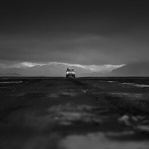 Dramatic view of 4x4 car driving toward camera in Highlands of Iceland during storm, Black and White [photography wall print]