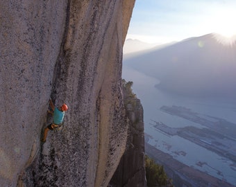 Climber on the top of the Stawamus Chief in Squamish at sunset climbing hard route [photography wall print]