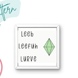 May include: A white framed print with the words "Leeb", "LeeFun", and "Lurve" written in black. A green diamond shape is in the center of the print.