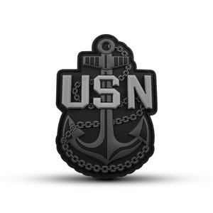 May include: Black and gray embroidered patch with a silver anchor and the text "USN" around it.