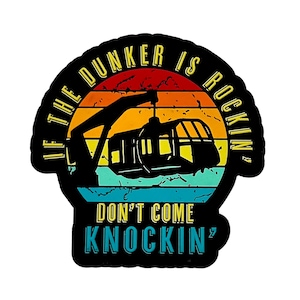 May include: Black sticker with a retro design featuring a gondola lift and the text "IF THE DUNKER IS ROCKIN' DON'T COME KNOCKIN'". The background has a sunset gradient of red, orange, yellow, and blue.