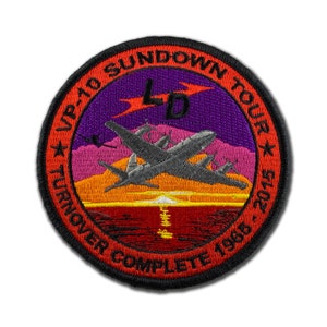 May include: A red, white, and black embroidered patch with the text "VP-10 SUNDOWN TOUR TURNOVER COMPLETE 1968 - 2015" and a stylized airplane flying over a sunset.