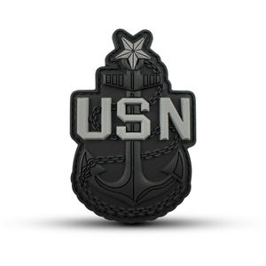 May include: Black and grey embroidered patch with a silver anchor, chain, and the text "USN".
