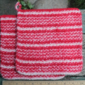 May include: Two red and white striped knitted pot holders with loops for hanging.