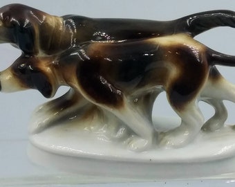 Japan Two Hunting Dogs Figurine.  Glazed Ceramic . Two Brown/Tan  Pointers . White base. Detailed Features.  Display. VIntage.