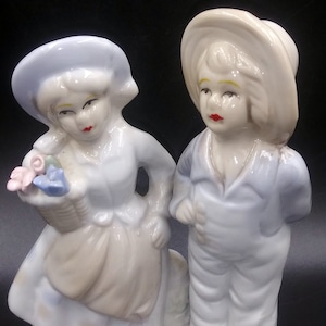 Vintage Porcelain Figurine:  Colorful Man and Woman with Hats and flowers.
