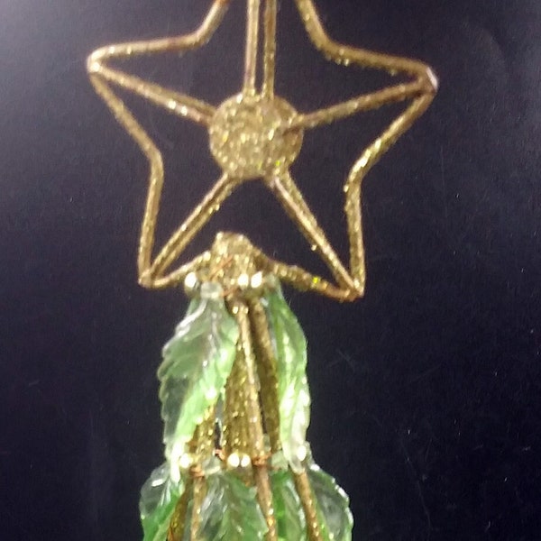 Gold colored wire/metal Christmas Tree.  Plastic green leaves. Gold beads. Glitter round base and big star. Christmas Decoration.