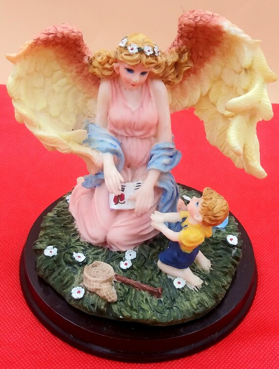 Kneeling Guardian Angel With Small Boy Figurine. Large White/pink Wings.  Open Book, Fishing Net. Green Grass/white Flowers. Collectible 