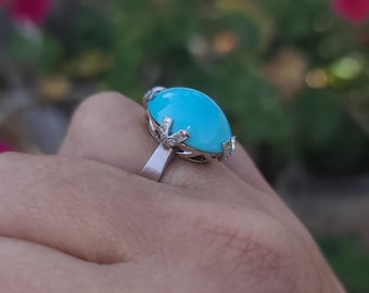 May include: A turquoise gemstone ring with a silver band and diamond accents.
