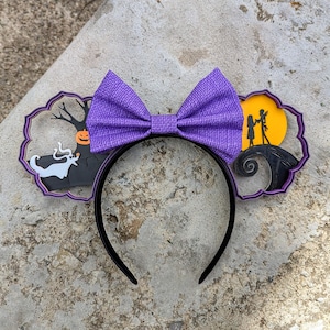 May include: Purple bow headband with a Nightmare Before Christmas theme. One side features Jack Skellington and Sally, the other side features Zero the ghost dog.
