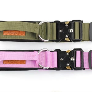 May include: Two dog collars, one green and one pink, with black buckles and silver rings. Both collars have the word "BOW'S" printed on them.