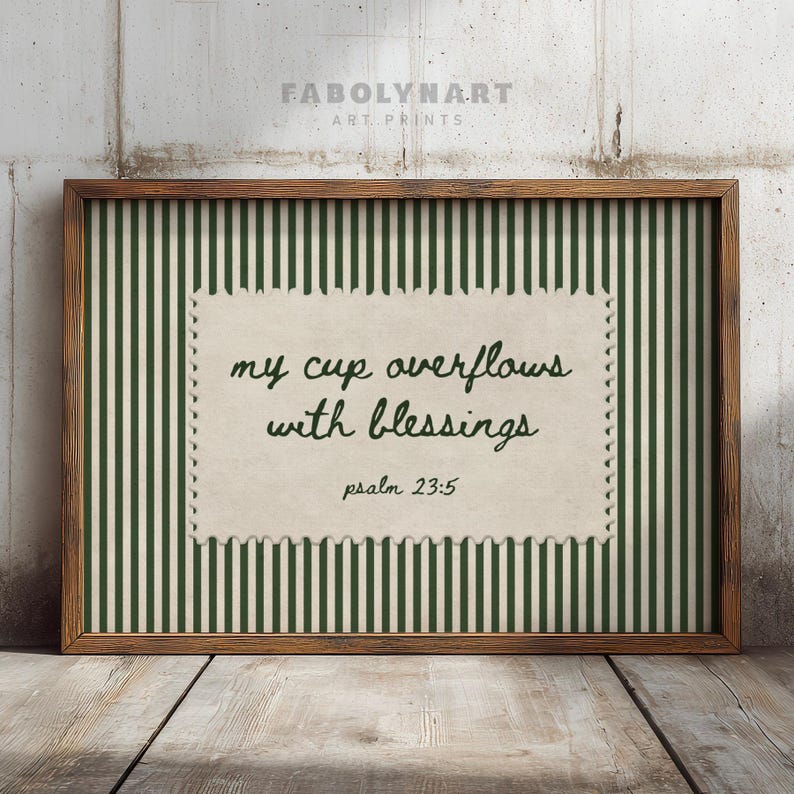 Framed wall art with green stripes and text "my cup overflows with blessings, psalm 23:5".
