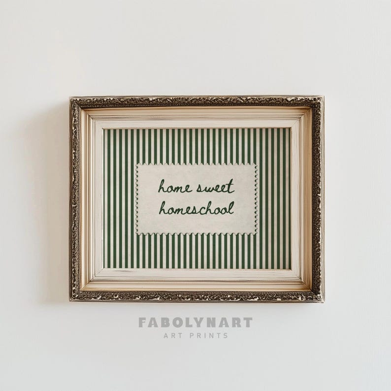 Ornate framed print with "home sweet homeschool" text on green stripes.
