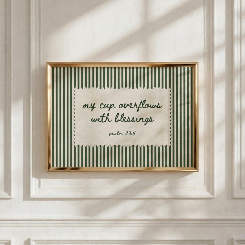 Framed artwork with green stripes and quote "my cup overflows with blessings."