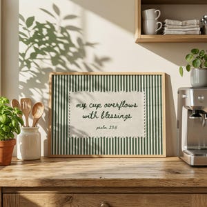 Framed print with green stripes and text "my cup overflows with blessings psalm 23:5".