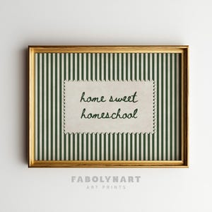 Framed print with green and white stripes, featuring "home sweet homeschool" text.