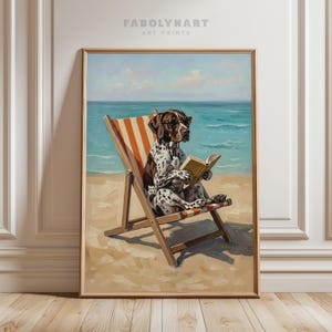 May include: A framed art print featuring a dog wearing sunglasses and reading a book while relaxing in a beach chair. The dog is brown and white, and the chair has orange and white stripes. The background shows the ocean and sky.