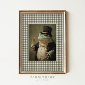 May include: Framed art print featuring a distinguished frog in a tuxedo, top hat, and holding a champagne glass. The artwork is set against a green and white checkered background, with the text "FABOLYNART ART PRINTS" at the bottom.