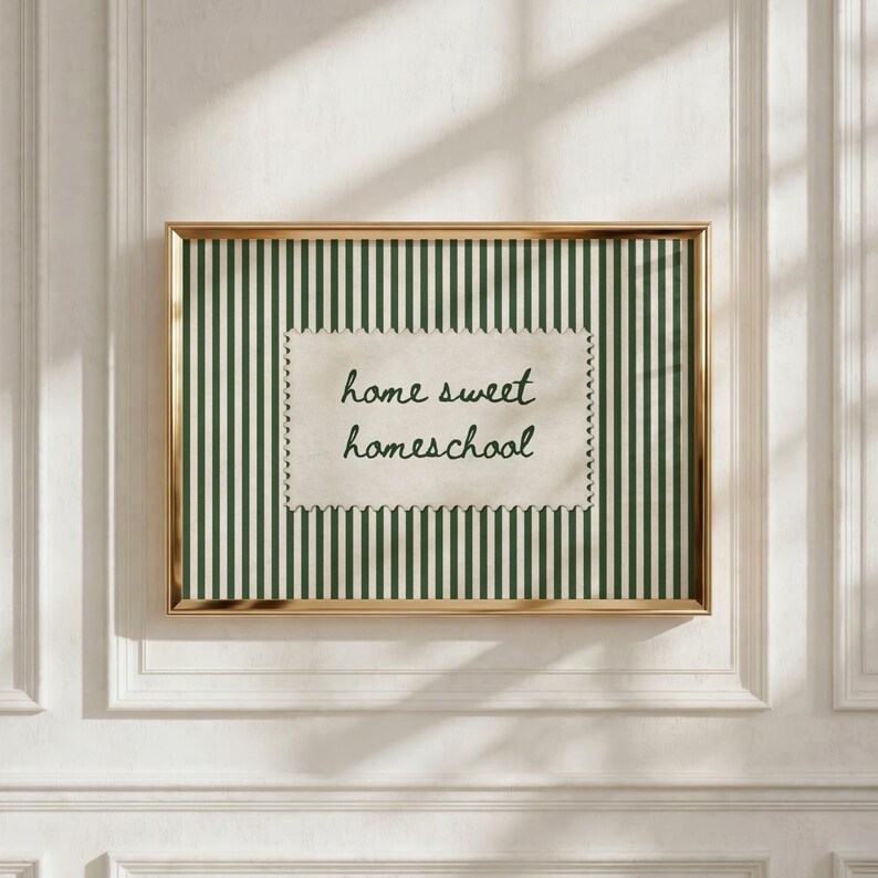 Framed artwork with green stripes and "home sweet homeschool" text on a scalloped tag.