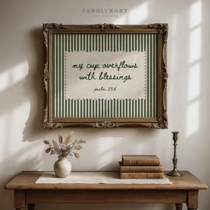 Ornate framed art with "my cup overflows with blessings psalm 23:5" text.