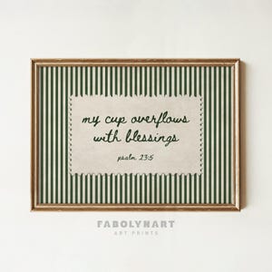 Framed art print with green and white stripes and text "my cup overflows with blessings psalm 23:5".