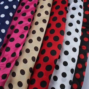 May include: Five fabric strips with a polka dot pattern. The strips are in different colors: navy blue, pink, beige, red, and white. The polka dots are black.