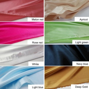 May include: A collection of fabric swatches in various colors, including melon red, apricot, rose red, light green, white, navy blue, light blue, and deep gold.