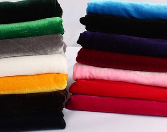 May include: A stack of 10 different colored velvet fabric swatches. The colors are green, gray, white, yellow, brown, black, blue, purple, red, and pink.