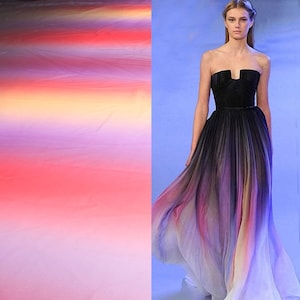 May include: A strapless ombre gown with a black bodice and a flowing skirt with shades of pink, purple, and yellow.