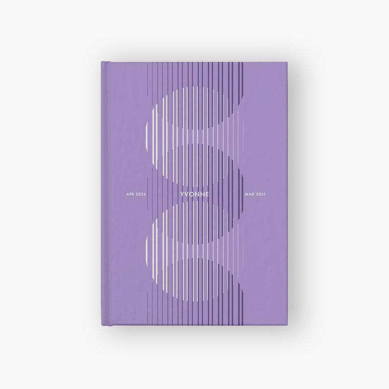 May include: A hardcover journal in a lavender hue. The cover features a white and purple vertical line design forming a stylized "S" shape. The name "YVONNE" is centered, with "APR 2024" and "MAR 2031" on either side.