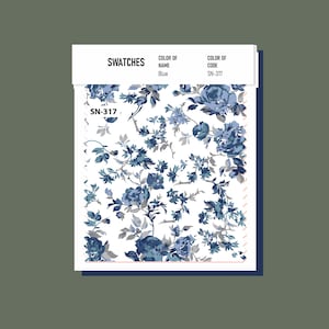 May include: Swatch of blue floral fabric with a white background. The fabric has a small, delicate floral pattern with blue and gray flowers. The swatch is labeled "SN-317".