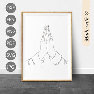 May include: Line art drawing of two hands clasped together in prayer. The drawing is in black and white and is framed in a wooden frame.