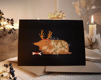 Set: folded Christmas card + envelope, festive dog with antlers, A6 postcard