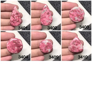 May include: Six pink and white cabochon gemstones with different shapes and sizes. The gemstones are labeled with numbers 3401, 3402, 3403, 3404, 3409, and 3410.
