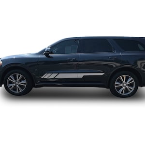 May include: A black Dodge Durango SUV with silver accents on the side. The vehicle has tinted windows and black wheels.
