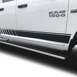 May include: White Ram 1500 pickup truck with black side step and black and white graphic stripes on the side. The truck has a Hemi 5.7 Liter badge on the side.
