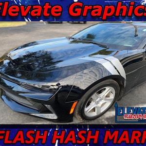 May include: Black Chevrolet Camaro with a white and gray hash mark decal on the side of the car. The decal is a flash hash mark design. The car is parked on a gray asphalt surface. The text "Elevate Graphics" is in red letters at the top of the image. The text "FLASH HASH MARK" is in red letters at the bottom of the image.