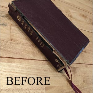 May include: A worn, burgundy leather-bound New Geneva Study Bible with a bookmark. The text on the spine reads "New Geneva Study Bible, New King James Version".