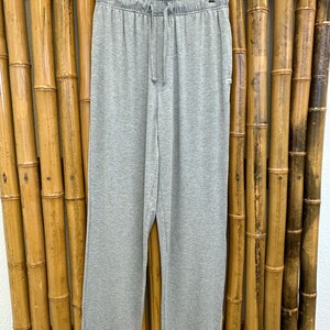 May include: Gray sweatpants with a drawstring waist.