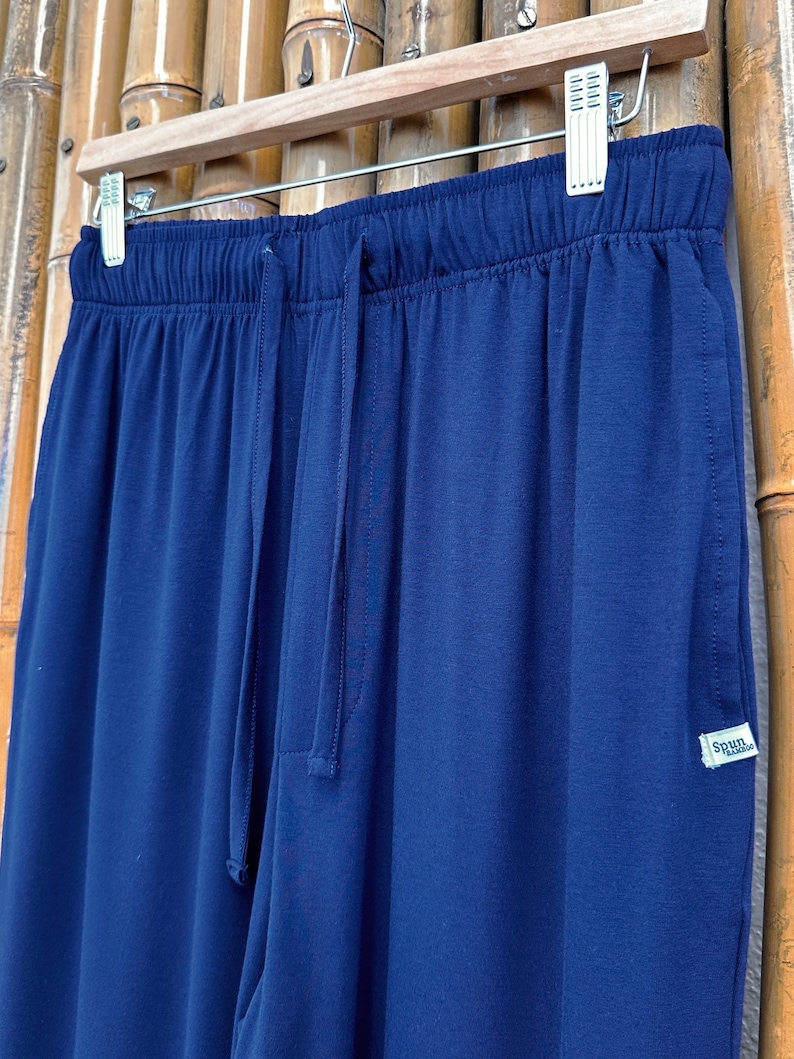 May include: Navy blue sweatpants with a drawstring waist and a small "Spun Bamboo" label on the right side.