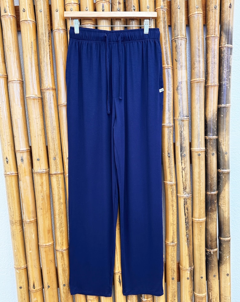 May include: Navy blue lounge pants with a drawstring waist and a small tag on the right hip.