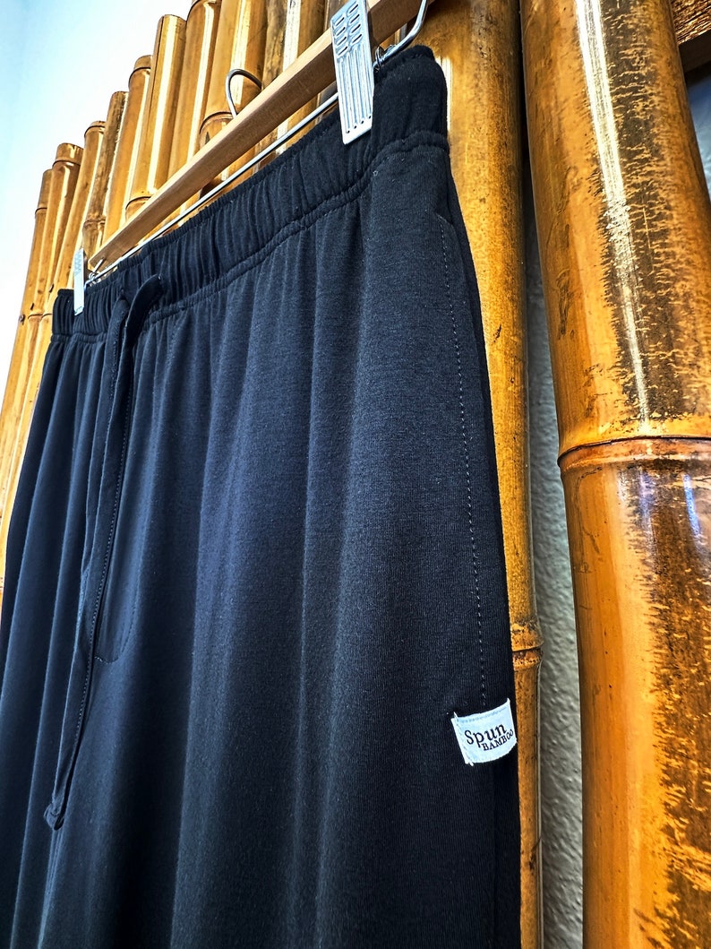 May include: Black drawstring sweatpants with a white tag that says "Spun Bamboo".