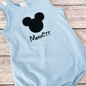 May include: A blue and white striped baby onesie with a black Mickey Mouse silhouette and the name "Merritt" embroidered on the front.