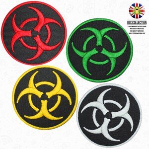 May include: Four embroidered iron-on patches with a biohazard symbol in red, green, yellow, and white. The patches are circular and have a black background.
